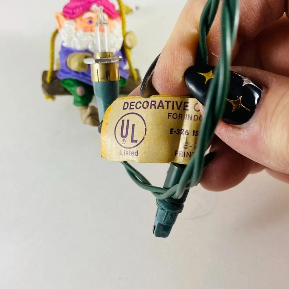 Adorable little Christmas elf holding a light bulb very vintage